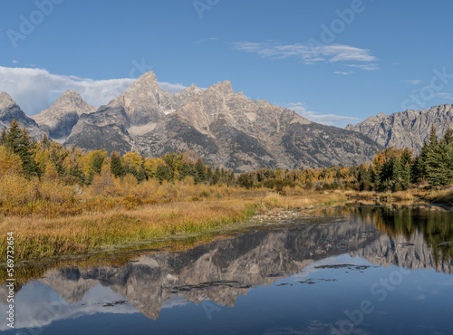 Grand Teton Mountain Range with autumn colors reflect in water of Snake River at Schwabacher’s Landing, Grand Teton National Park © Lee