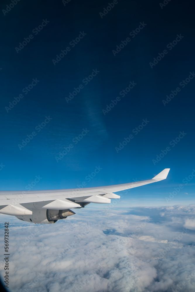 Fototapeta premium flying and traveling. Airplane interior or jet window with clouds and sky. Sky view from a high angle on the plane. 
