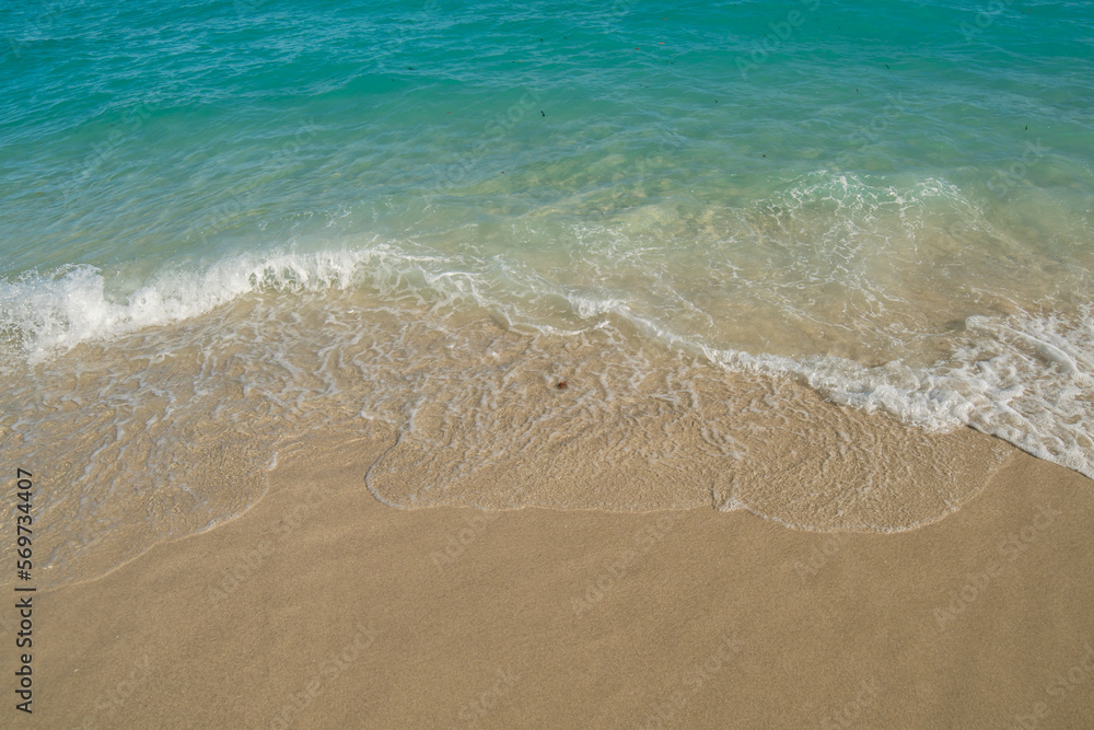 Beautiful Soft blue ocean wave on fine sandy beach. Blue ocean waves aerial drone shot on sandy beach. 
