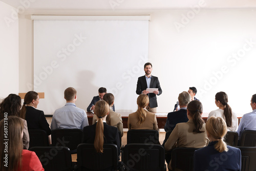 Business conference. People in meeting room listening to speaker report