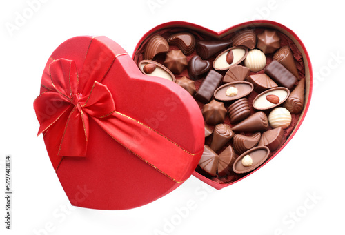 Heart shaped box with delicious chocolate candies isolated on white, top view © New Africa