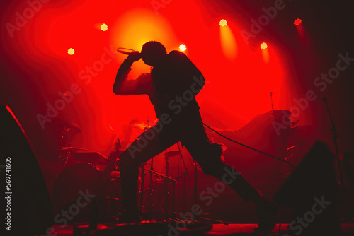 silhouette of a dancing man with a microphone in a red background