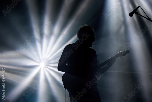 silhouette of a person with a guitar