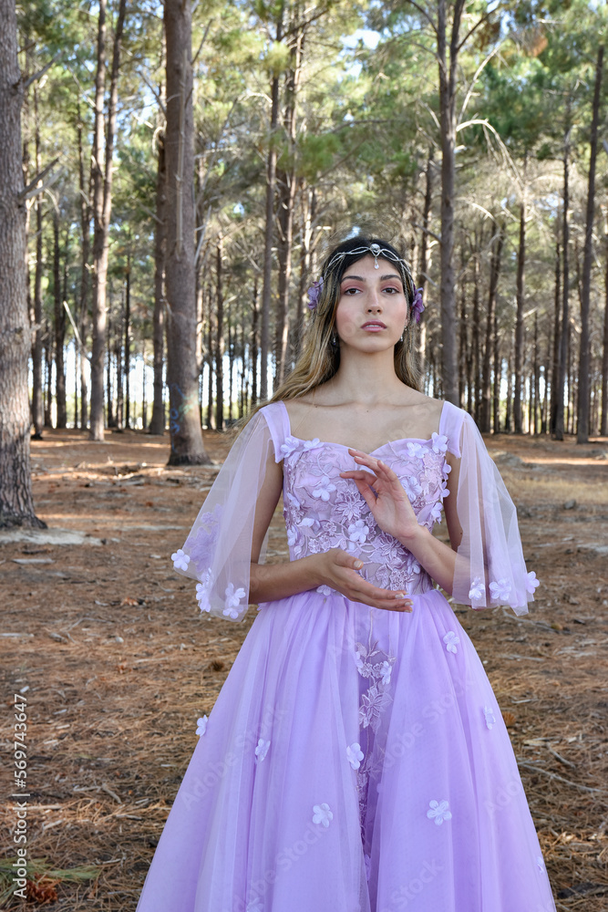 Close up portrait of beautiful young blonde model wearing a purple princess fantasy ball gown with flower crown diadem.
Pine forest location background with golden lighting. Close up portrait of beautiful young blonde model wearing a purple princess fantasy ball gown with flower crown diadem.
Pine forest location background with golden lighting.