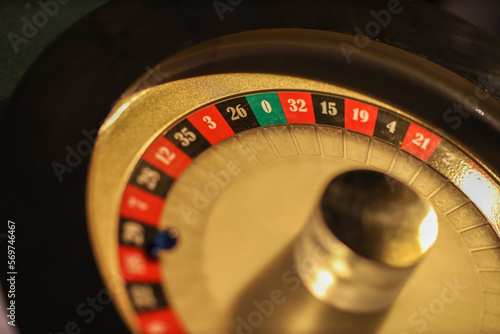 Gold casino theme. Image of casino roulette  poker games  money on the table  all on a dark bokeh background. Place for printing 