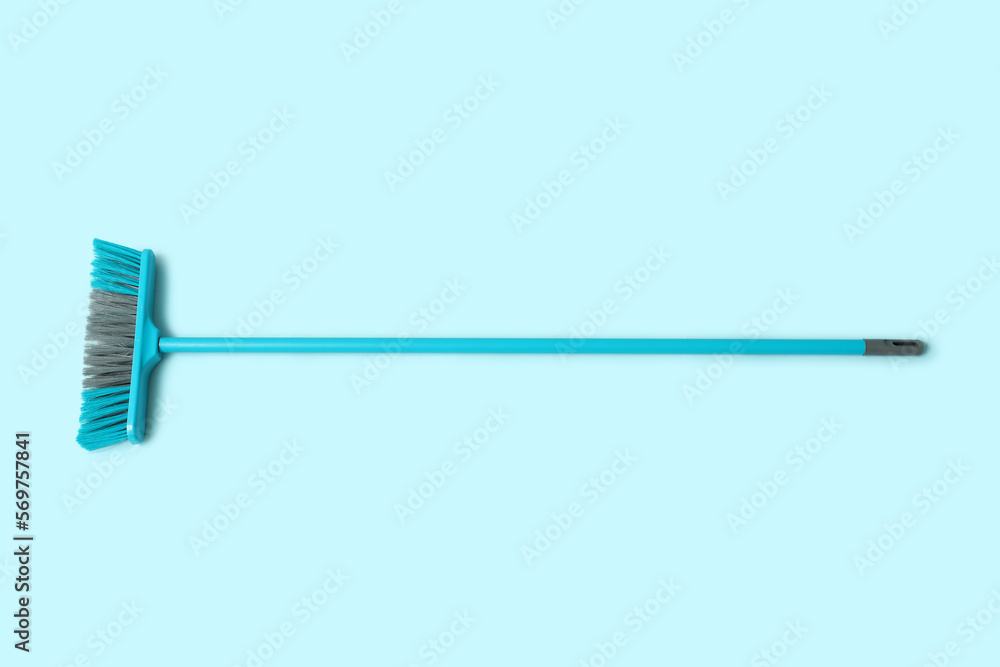 Cleaning broom on blue background Cleaning broom on blue background