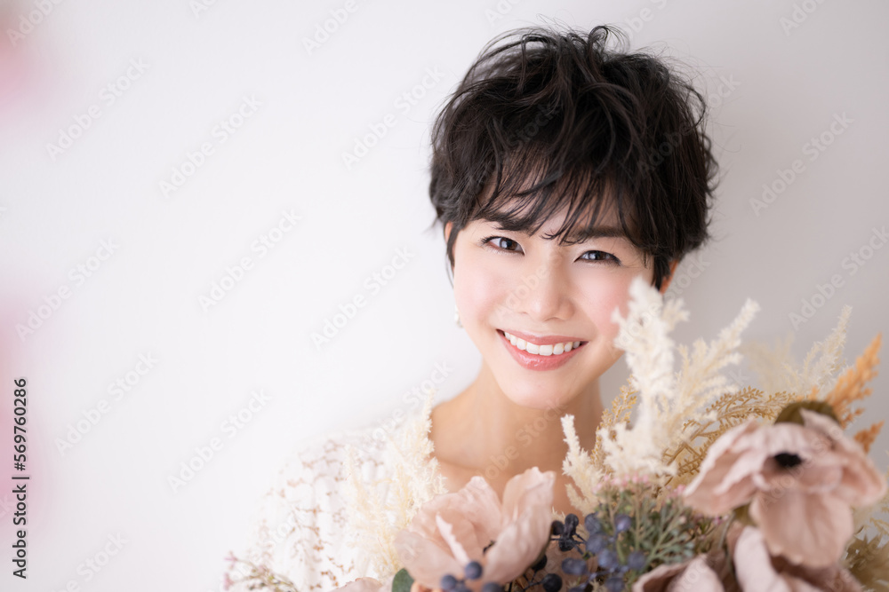 Image of a pretty Asian woman in pink and spring Crumpled smile Up Image of a pretty Asian woman in pink and spring Crumpled smile Up