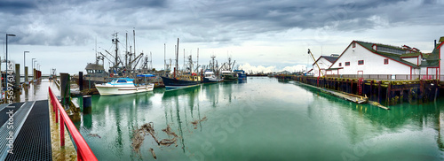 Panoramic view of the Steveston Fisherman's Wharf. Fishing boats and sailboats in Steveston harbor. Richmond, BC, Canada photo