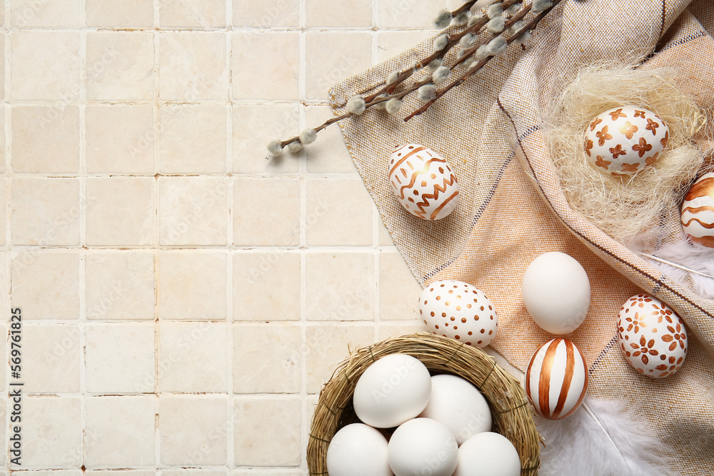 Composition with beautiful Easter eggs and willow branches on light tile Composition with beautiful Easter eggs and willow branches on light tile