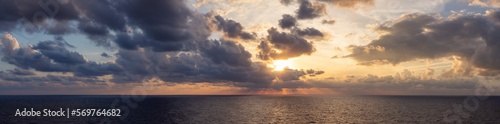 Dramatic Colorful Sunset Sky over Mediterranean Sea. Clouds with Sunrays. Cloudscape Nature Background. Panorama