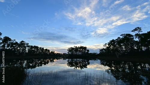 Time lapse of sunset cloudscape over Long Pine Key lake and campground in Everglades National Park, Florida 4K.