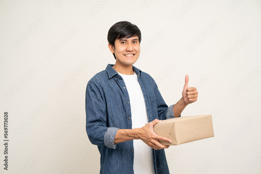 Young excited asian man with many parcel cardboard standing on isolated white background. Cheerful male holding lot of parcel box receive from the delivery service Young excited asian man with many parcel cardboard standing on isolated white background. Cheerful male holding lot of parcel box receive from the delivery service
