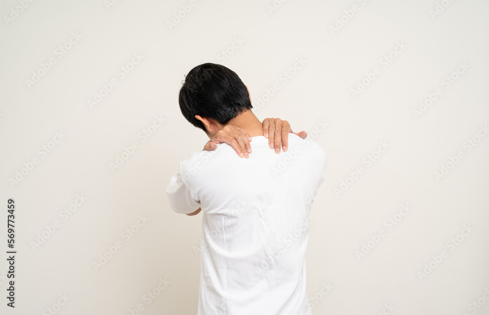 Young Asian man has problem with structural posture He had neck and shoulder pain. Massaged his neck and shoulders for relief. reduce muscle tension. Standing on isolated white background Young Asian man has problem with structural posture He had neck and shoulder pain. Massaged his neck and shoulders for relief. reduce muscle tension. Standing on isolated white background