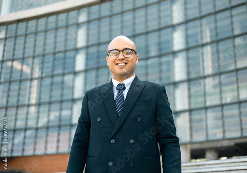 Senior manager business man in suit thumbs up at the buildings downtown. Confident man looking towards their goals for success. Executive business man