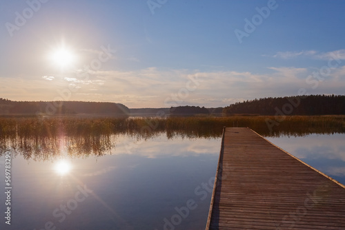 Fototapeta Naklejka Na Ścianę i Meble -  Little bridge in the lake at sunset. Landscape for background