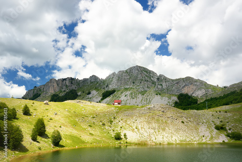 Scenic landscape of mountain valley with Bukumirsko Lake in alps of Montenegro. Stunning view of mountains and valleys in sunset light photo