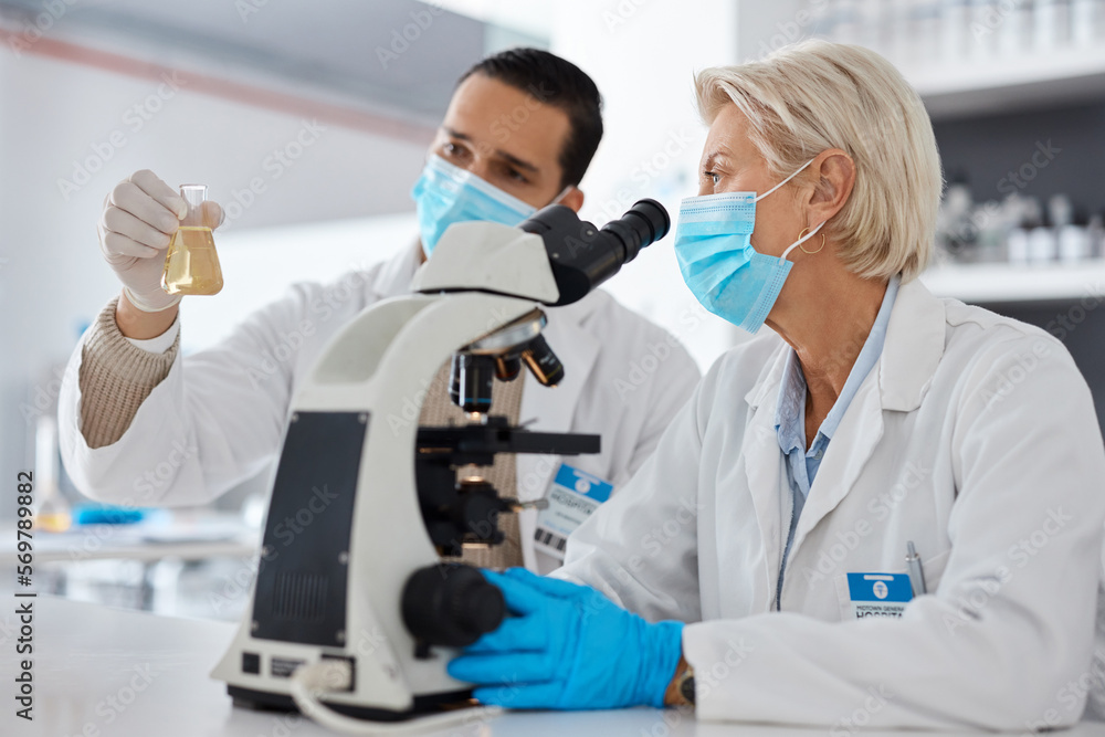 Science, mask and man with woman, liquid and experiment with cure, breakthrough and conversation in laboratory. Female scientist, male research and face cover for protection, safety and test tube Science, mask and man with woman, liquid and experiment with cure, breakthrough and conversation in laboratory. Female scientist, male research and face cover for protection, safety and test tube
