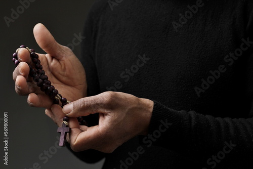 praying to god with cross and hands together with black background with people stock image stock photo 