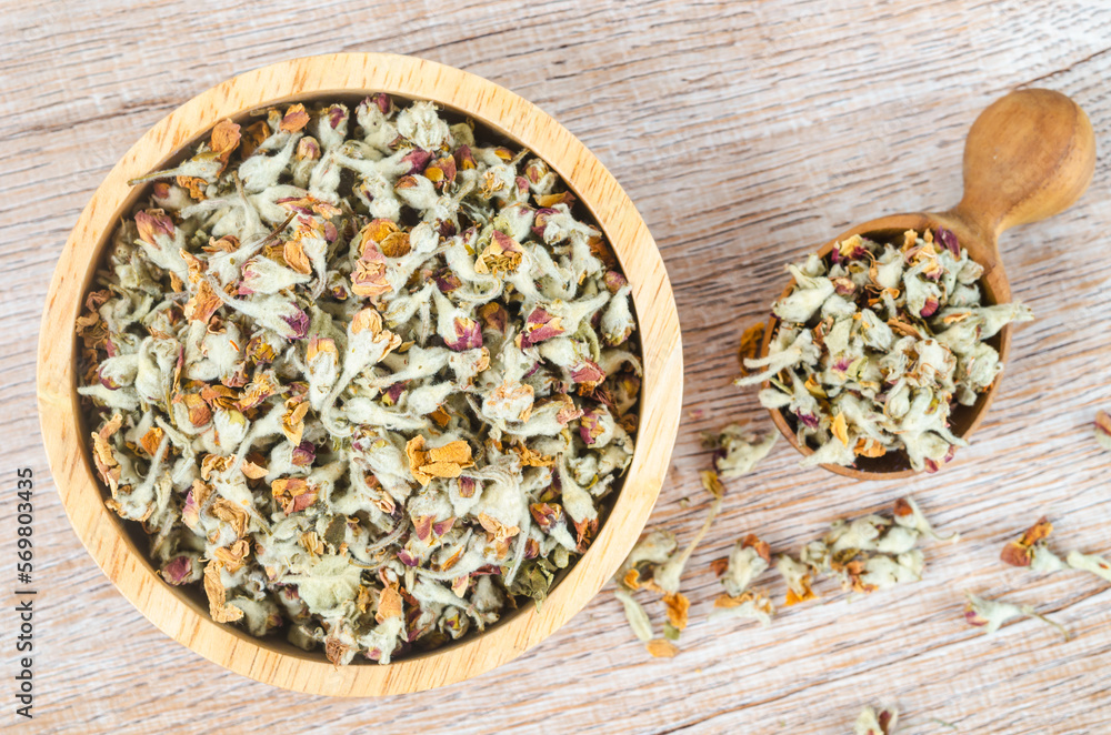 TheFlower tea. Dried of apple blossom in wooden spoon. TheFlower tea. Dried of apple blossom in wooden spoon.