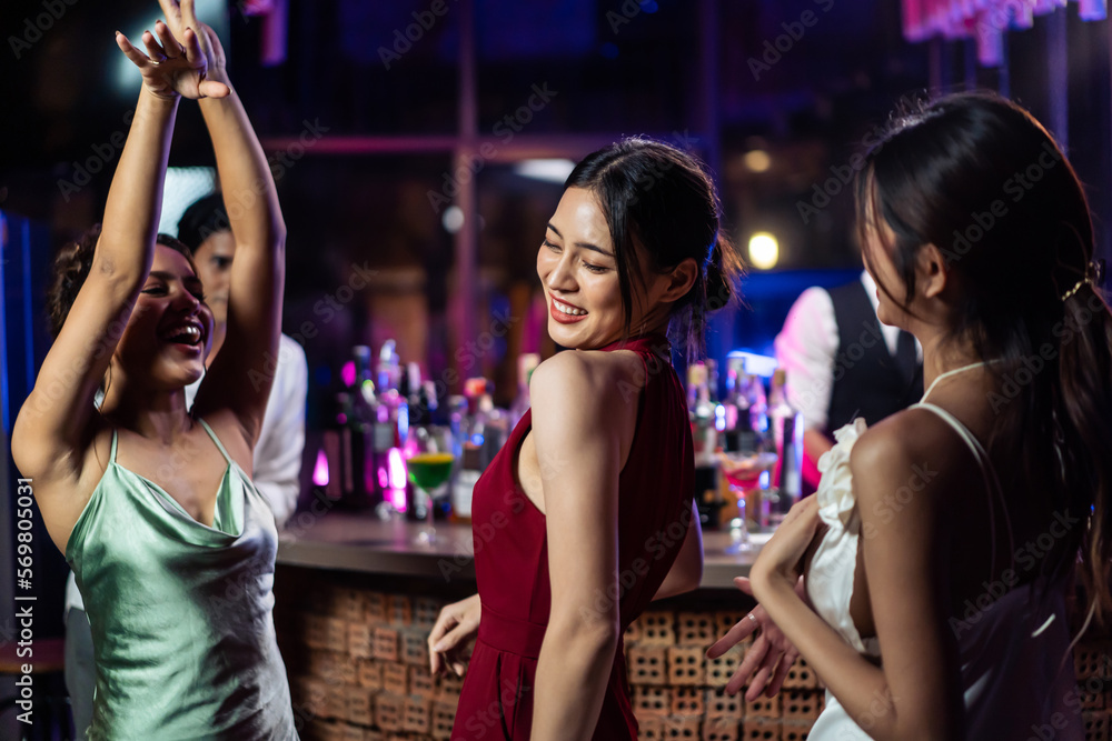 Asian beautiful woman having fun, dancing with music in bar restaurant. 