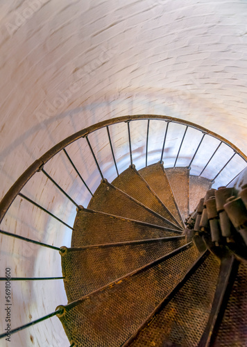 High angle perspective view of spiral stairs in Cape Florida Lighthouse in Miami  Florida. Vertical shot of metal spiral stairs inside the lighthouse at Bill Baggs Cape Florida State Park.