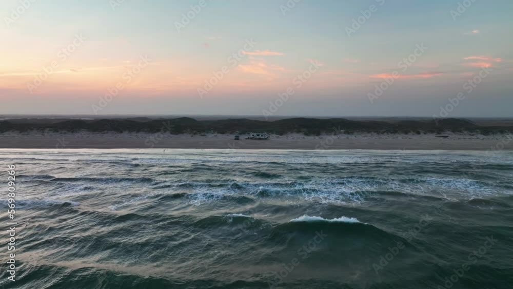 Flying Through The Seascape With Camper Van At The Shore Of Padre Island National Seashore In Texas. Aerial Drone Shot