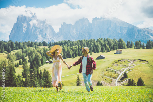 Happy couple on vacation on the italian dolomites mountains