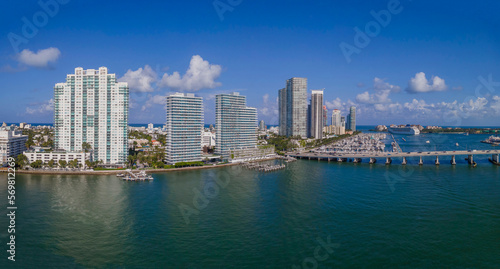 Panorama of builings and highway over Intracoastal Waterway in Miami Florida. Scenic urban skyline against a manmade inland water channel and bright blue sky on a sunny day. © Jason