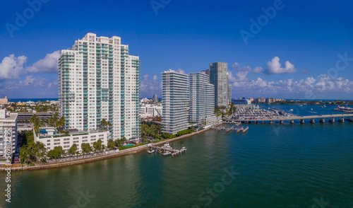 Buildings and highway over the Intracoastal Waterway in Miami Beach Florida. Scenic urban landscape with city skyline against blue sky, clouds, and manmade inland water channel. © Jason