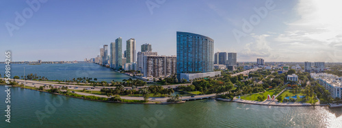 Scenic panorama of the Intracoastal Waterway and city skyline in Miami Florida. Aerial view of beautiful modern buildings, roads, and trees against a man-made inland water channel.