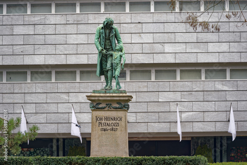 Bronze statue of Johann Heinrich Pestalozzi made by Hugo Siegwart 1898 at famous Bahnhofstrasse at City of Zürich on a gray and cloudy winter day. Photo taken February 8th, 2023, Zurich, Switerland. photo