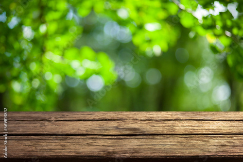 wooden table with forest bokeh background