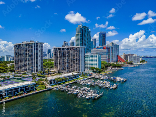 Harbor on Miami South Channel with skyscrapers against blue sky background- Miami Beach, Florida. Coastline modern high-rise buildings in an aerial view.