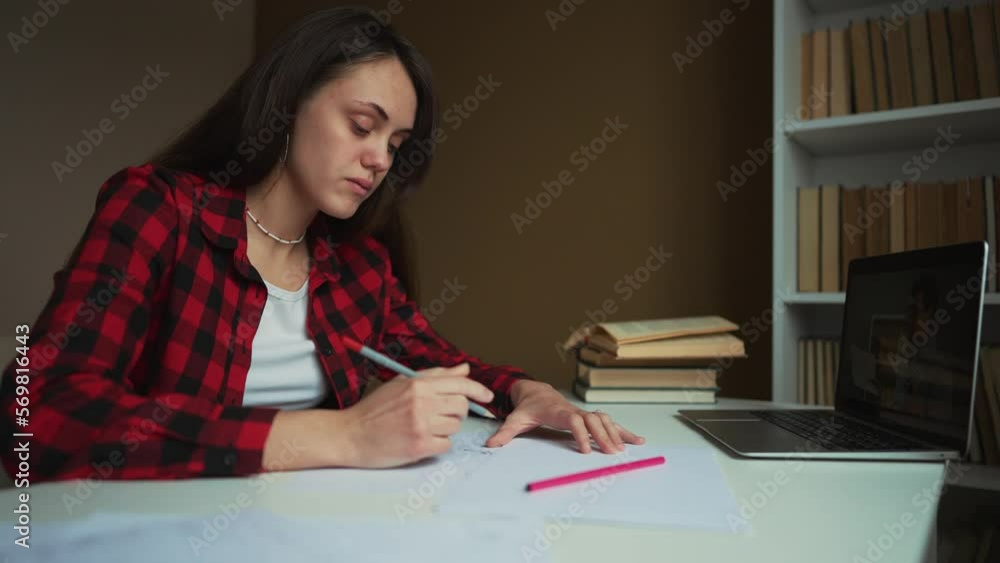 Girl of the student studies at home remotely. The student is engaged with the help of a service on a computer. The girl uses a computer and its services to study at home. Online school new normal Girl of the student studies at home remotely. The student is engaged with the help of a service on a computer. The girl uses a computer and its services to study at home. Online school new normal