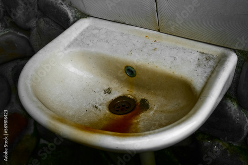 фотографія close up view of the dirty stain inside of the toilet sink in the house