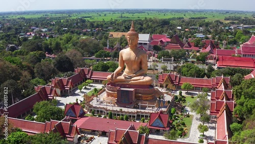 Aerial view of Wat Pikul Thong Phra Aram Luang or Wat Luang Por Pae temple with giant Buddha, in Sing Buri, Thailand photo