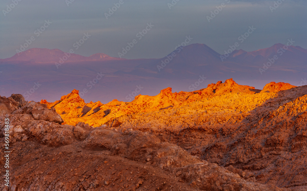 Last sunrays of the day hit the barren rocks in the Moon Valley (Valle de la Luna) in the vicinity of San Pedro de Atacama, Chile