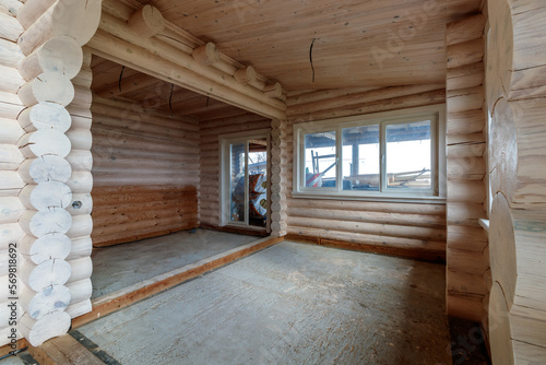 A two-story wooden cottage from the inside out in coniferous spruce pine green forest © Dzmitry Halavach