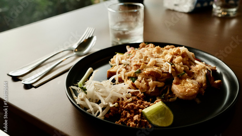 Pad Thai and drinking water on the table.