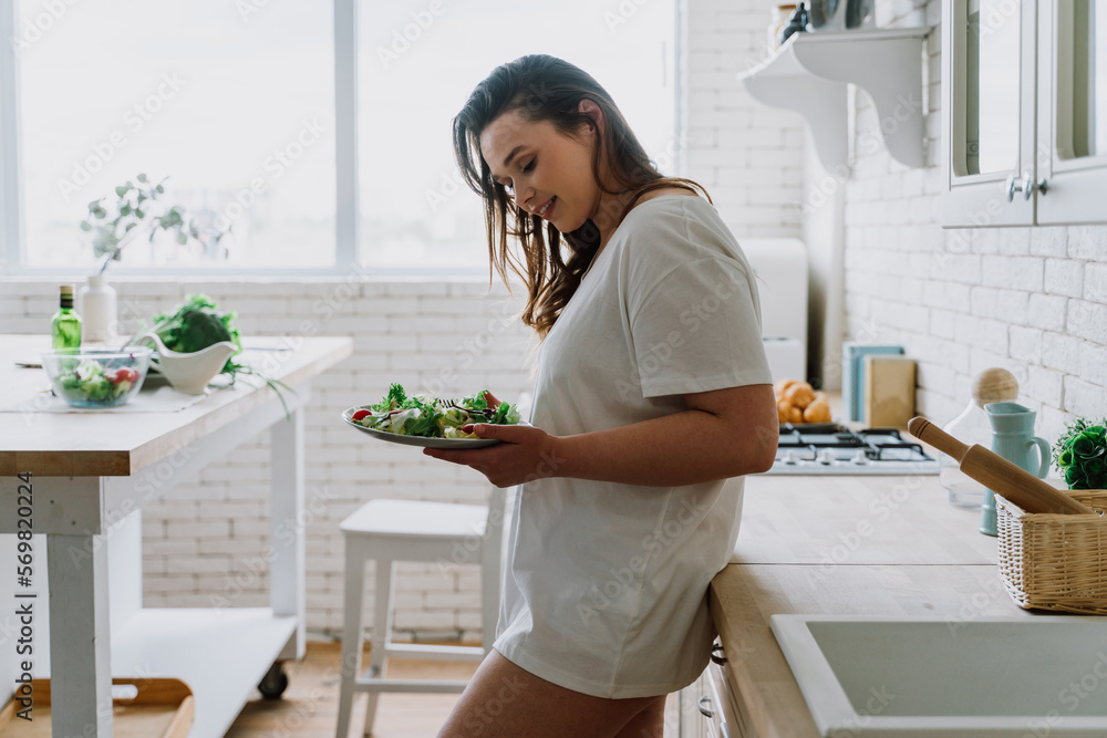 woman preparing a salad in the kitchen woman preparing a salad in the kitchen