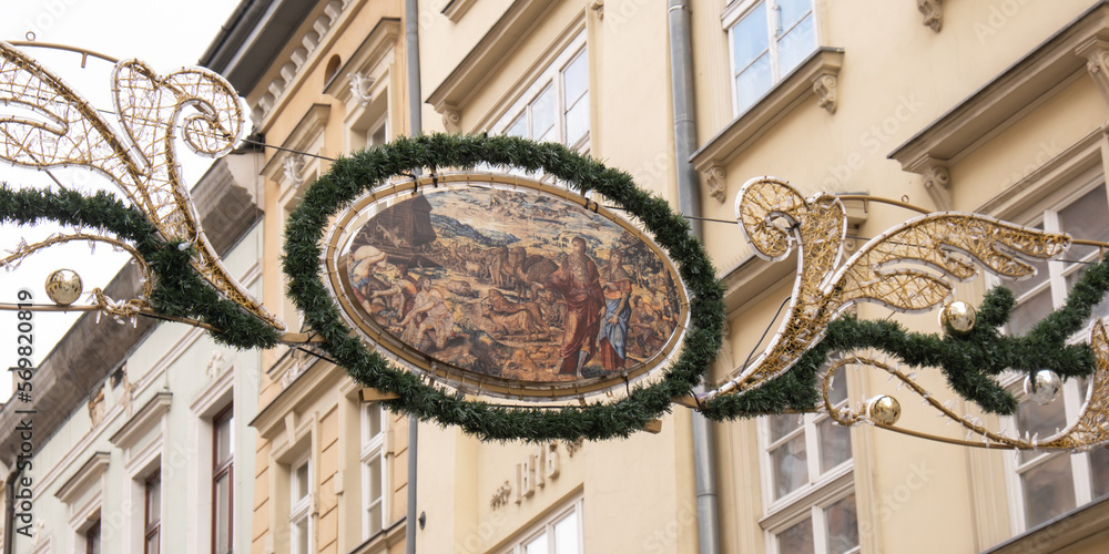 Fototapeta premium Krakow Main Square Rynek Glowny Poland christmas decorations. Krakow architecture, old city architecture. Historic church in Krakow Baroque architecture Travel tourist attraction