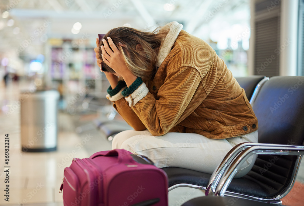 Upset woman, airport and flight delay sitting on bench in travel restrictions or plane cancelation with luggage. Angry, sad or disappointed female in frustration for missing boarding schedule time - obrazy, fototapety, plakaty 