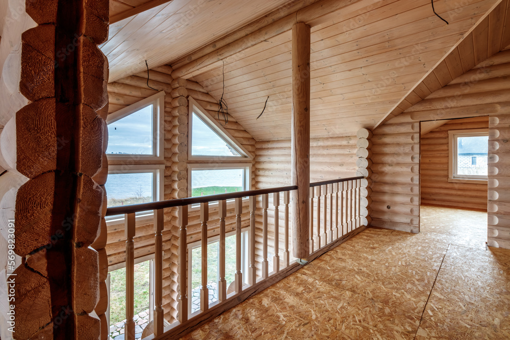 Obraz premium A two-story wooden cottage from the inside out in coniferous spruce pine green forest