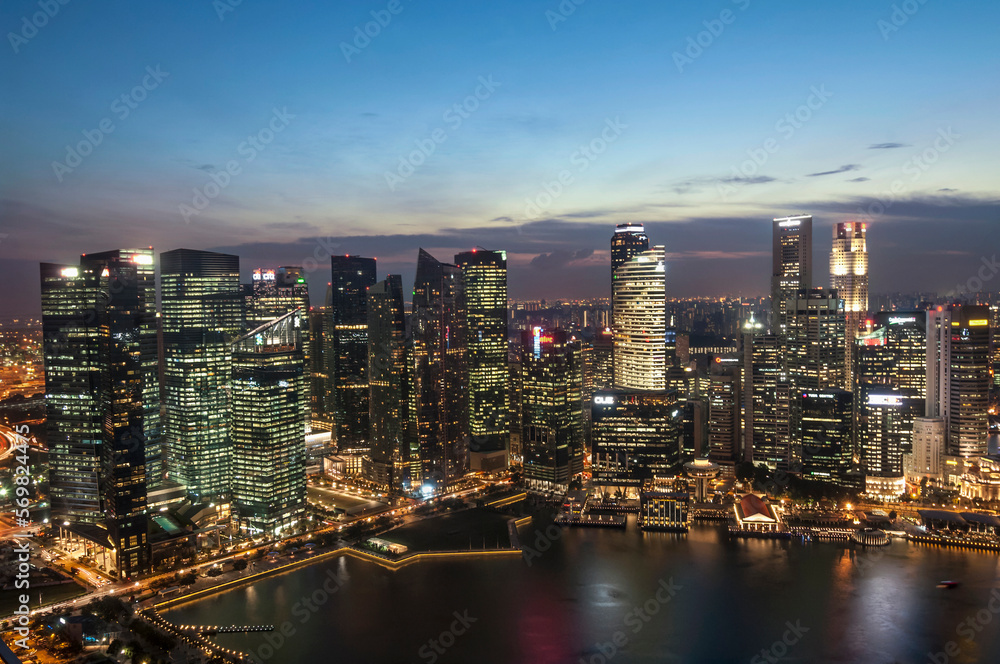 Skyscrapers lit up at night in a city, Singapore River, Singapore City, Singapore Skyscrapers lit up at night in a city, Singapore River, Singapore City, Singapore