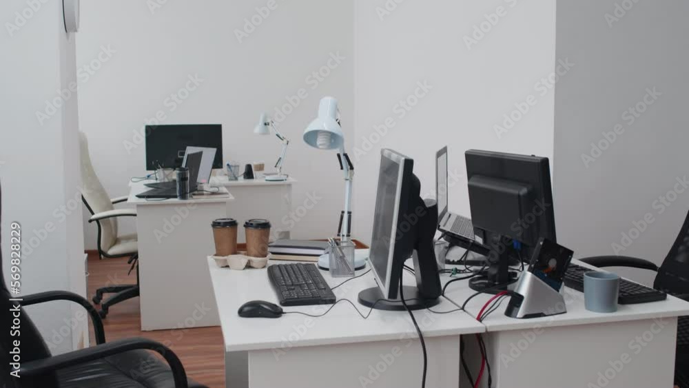 No people shot of modern open plan office interior with white desks, computers and lamps on them No people shot of modern open plan office interior with white desks, computers and lamps on them