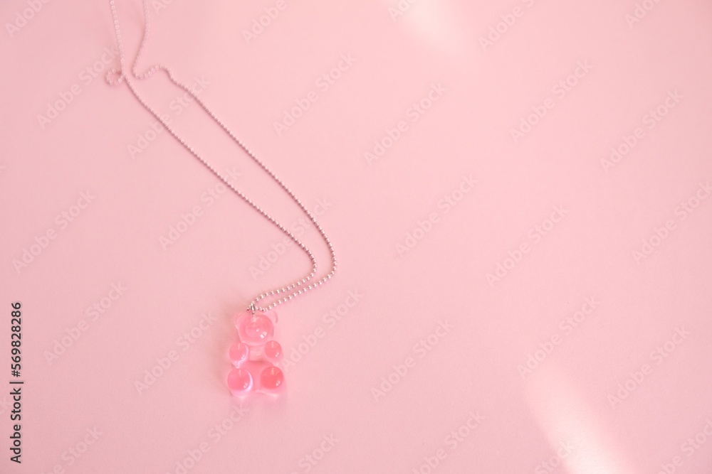 Children's  jewelry in the form of a bear on a pink background. Jewelry, costume jewelry.