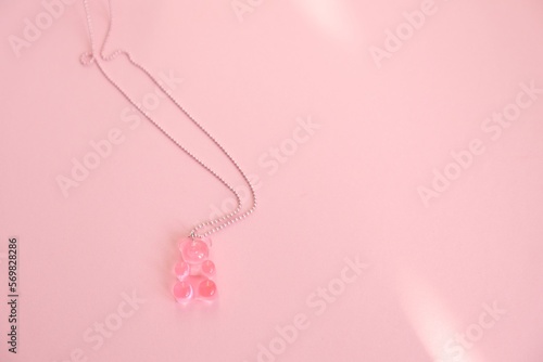 Children's jewelry in the form of a bear on a pink background. Jewelry, costume jewelry.