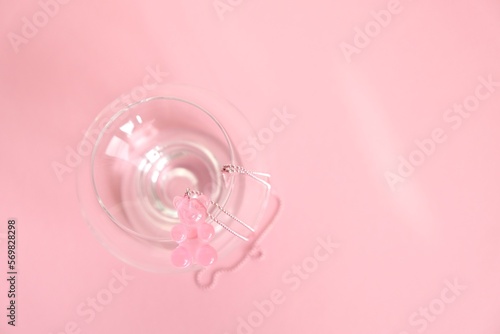 Children's jewelry in the form of a bear on a pink background. Jewelry, costume jewelry.