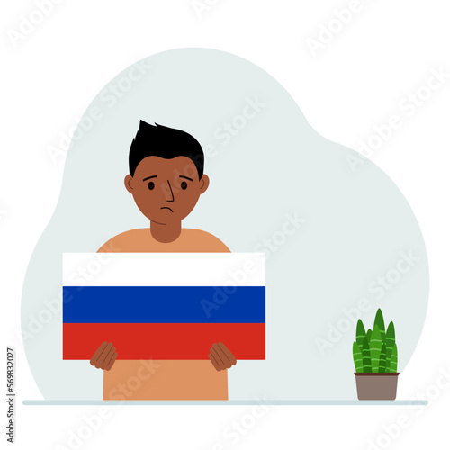A little boy is holding a Russian flag. The concept of demonstration, national holiday or patriotism. Nationality.