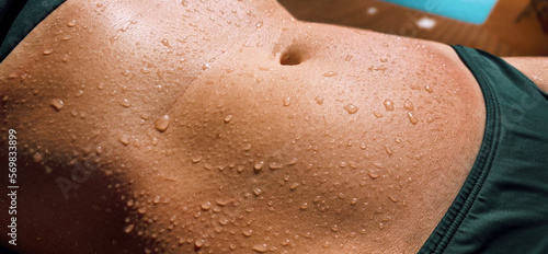 wet woman's body in bikini. water drops on stomach